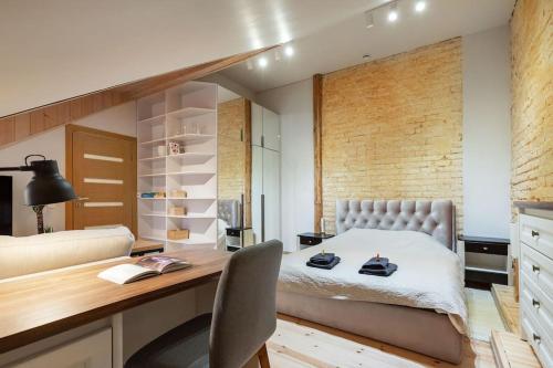 a bedroom with a bed and a desk with a chair at Luxury apartment in Gedimino av. in Vilnius