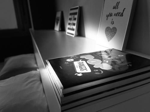 a book sitting on top of a bed with a light at Loft 1303 Maxplaza, Encantador, piscina, garagem in Canoas