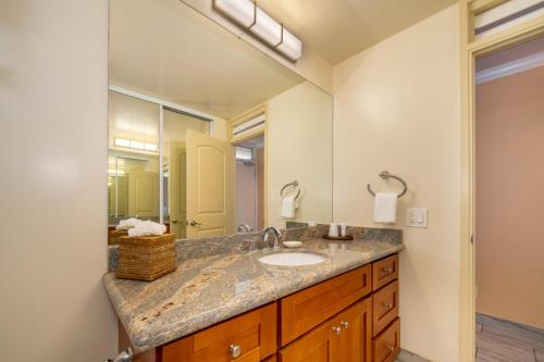 a bathroom with a sink and a large mirror at Napili Shores Maui by OUTRIGGER - No Resort & Housekeeping Fees in Lahaina