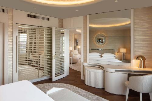 a hotel room with a bed and a desk and a bedroom at Sheraton Ankara Hotel & Convention Center in Ankara