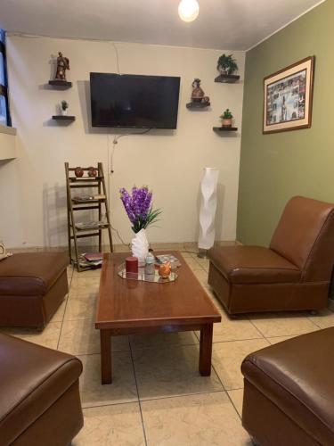 a living room with two couches and a coffee table at Hotel Acuario in Churín