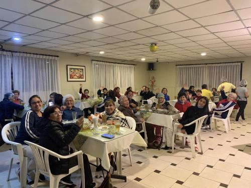 a group of people sitting at tables in a room at Hotel Acuario in Churín