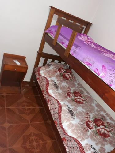 1 dormitorio con litera y mesa en Raquel alojamiento en Puerto Iguazú