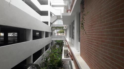 a hallway of a building with potted plants at BS Homestay5 - 2R2B Apartment with a Balcony in Miri