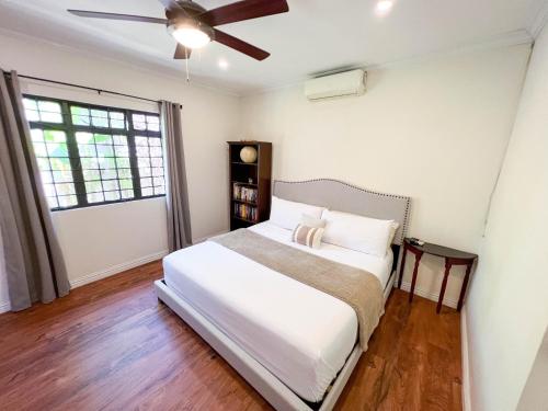 a bedroom with a bed and a ceiling fan at Westend House Newly Renovated 3 Bedroom in Petit Valley
