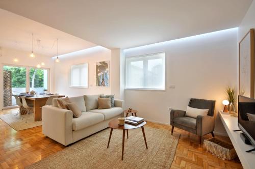 a living room with a couch and a table at Casa do Bieira for Family By Sé Apartamentos in Braga