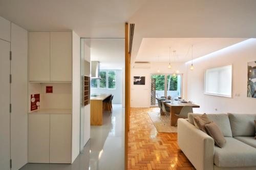 a living room and kitchen with a couch and a dining room at Casa do Bieira for Family By Sé Apartamentos in Braga