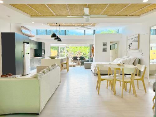 a living room with a couch and a dining room at Driftwood Villa's - Scotts Head in Scotts Head