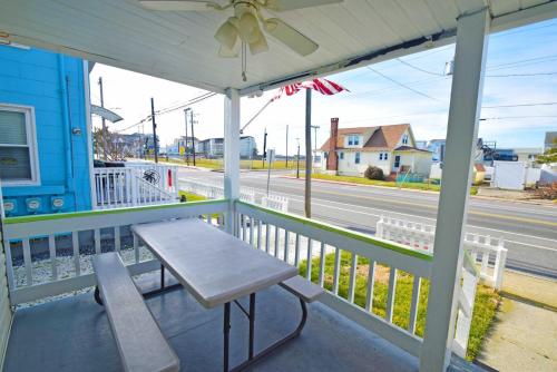 a porch with a bench and a view of a street at Parrot Bay-Key Lime 7 condo in Ocean City