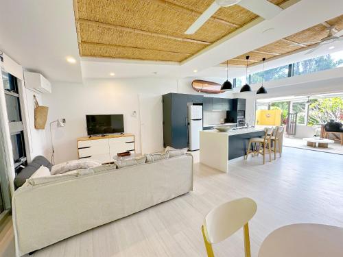 a living room and kitchen with a couch and a table at Driftwood Villa's - Scotts Head in Scotts Head