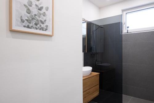 a bathroom with a sink and a glass shower at MH Living - 23 - Scandinavian Living Dream in Center in Graz