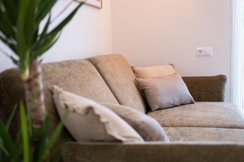a couch with pillows on it in a living room at MH Living - 23 - Scandinavian Living Dream in Center in Graz