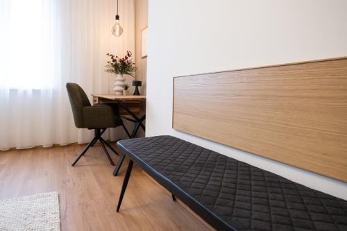 a bed in a room with a desk and a chair at MH Living - 23 - Scandinavian Living Dream in Center in Graz