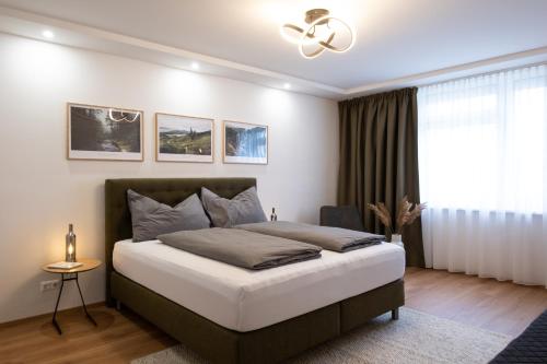 a bedroom with a bed and a ceiling fan at MH Living - 23 - Scandinavian Living Dream in Center in Graz