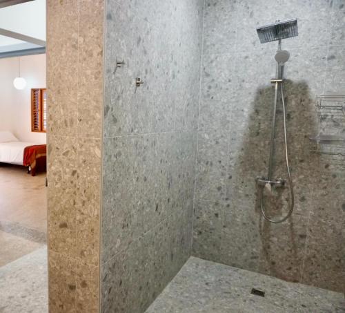 a bathroom with a shower with a glass door at Gordon Town Kotch in Kingston