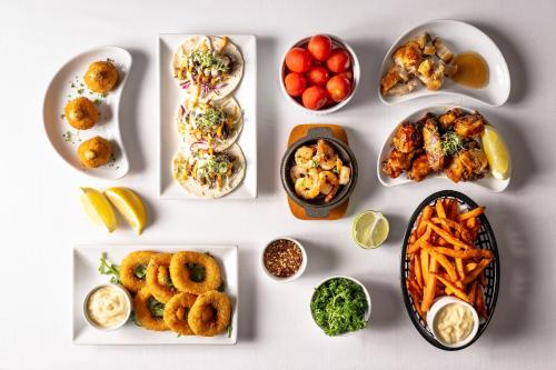 a white table with different types of food on it at Red Sands Accommodation Newman in Newman