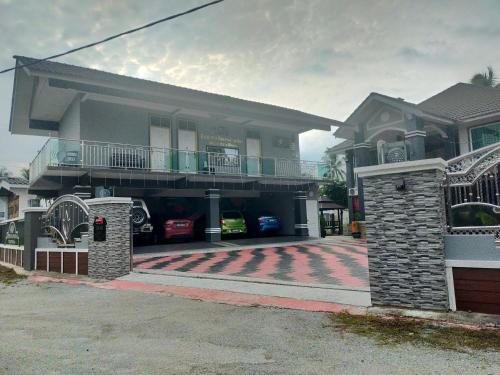 a house with a gate in front of it at Airport Kota Bharu Transit Inn in Kota Bharu
