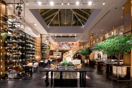 a lobby of a store with a table and chairs at Montien Hotel Surawong Bangkok in Bangkok