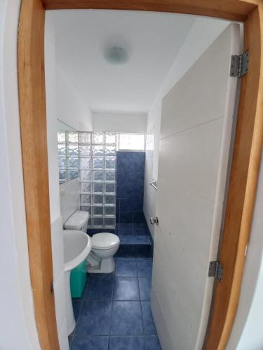 a bathroom with a toilet and a sink at DÚPLEX CON VISTA A TODA LA BAHÍA DE NAPLO in Pucusana