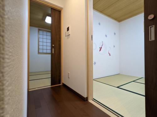 an empty hallway with a room with a basketball court at Kaika Inn in Osaka