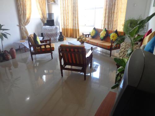 a living room with chairs and a couch at Asoka Resident Kalutara in Kalutara