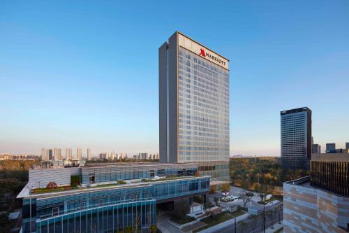 a tall building with a sign on it in a city at Jiaxing Marriott Hotel in Jiaxing
