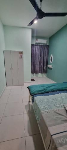 a bedroom with two beds in a room with a window at Flora Homestay Jenjarom, Banting,Telok Panglima Garang in Jenjarum