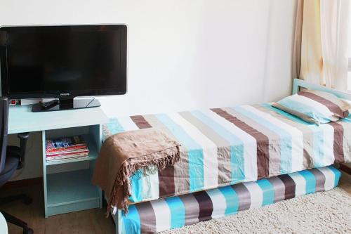 a bedroom with a bed and a desk with a television at Studio 22 square meters In The Center Of Lyon in Lyon