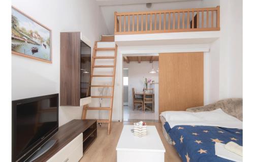 a small bedroom with a bunk bed and a staircase at 2 Bedroom Stunning Apartment In Zuljana in Žuljana