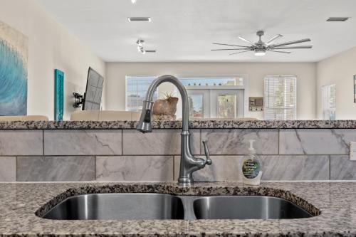 a kitchen with a sink and a counter top at Blue Oasis Beach Vacation Home with Private Pool & Hot Tub in Panama City Beach