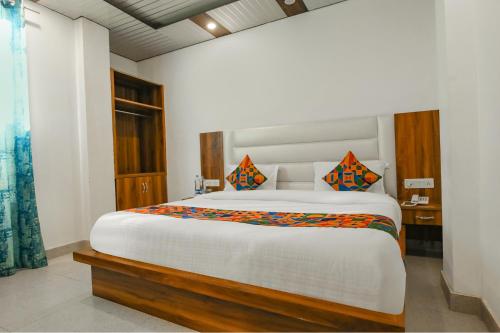 a bedroom with a large bed in a room at FabExpress Sagar Residency in Mussoorie