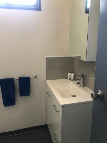 a bathroom with a white sink and a mirror at Broome Vacation Village in Broome