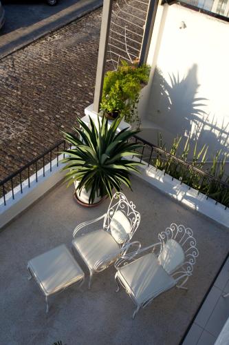two chairs and a plant on a patio at Pousada Casa da Vitória in Salvador