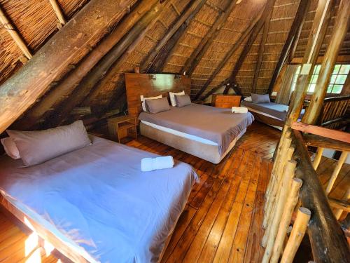 a bedroom with two beds in a attic at Pine Valley in Lanseria
