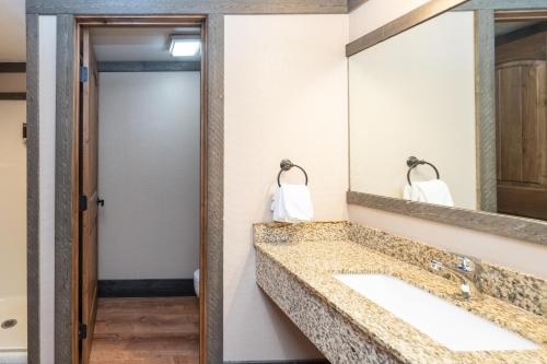 a bathroom with a sink and a mirror at Mountainside Inn 412 by Alpine Lodging Telluride in Telluride