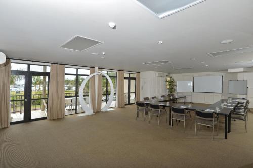 a conference room with a long table and chairs at Quality Hotel Oceans Tutukaka in Tutukaka