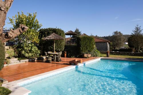 een zwembad in een tuin met een huis bij Quinta Sao Miguel de Arcos in Vila do Conde