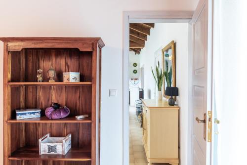 um corredor com uma estante de livros de madeira numa casa em Armando Cottage em Pandokrátor