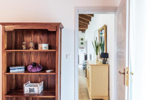 a hallway with a wooden book shelf in a house at Armando Cottage in Pandokrátor