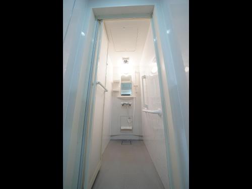 a small bathroom with a toilet and a corridor at WELLCABIN TENJIN - Male Only in Fukuoka