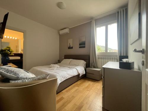 a bedroom with a large bed and a window at Horizon Suites in Cefalù