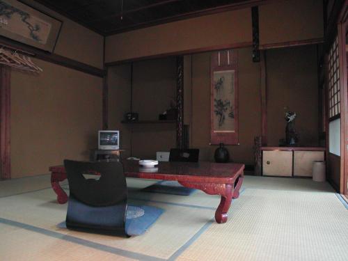 a room with a table and a computer in it at Hanaya Tokubei in Tenkawa