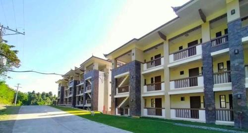 un gran edificio de apartamentos con una calle enfrente en Kembali CONDO Resort with Sea View, en Davao City