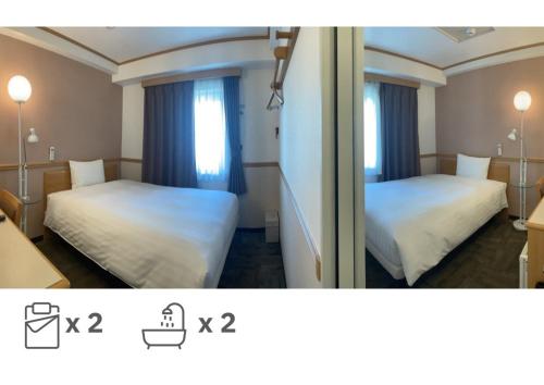 een hotelkamer met 2 bedden en een raam bij Toyoko Inn Busan Seomyeon in Busan