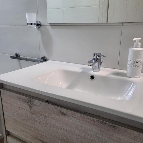 a white sink in a bathroom with a mirror at Sole raggiante Lia Darzillo in Afragola