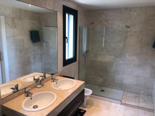 a bathroom with two sinks and a shower at Detached house with pool nearby Girona in Sant Julià De Ramis