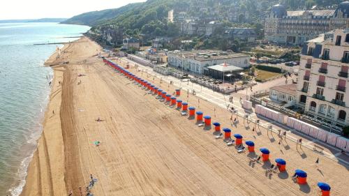an aerial view of a beach with umbrellas at Hôtel de la Plage in Houlgate