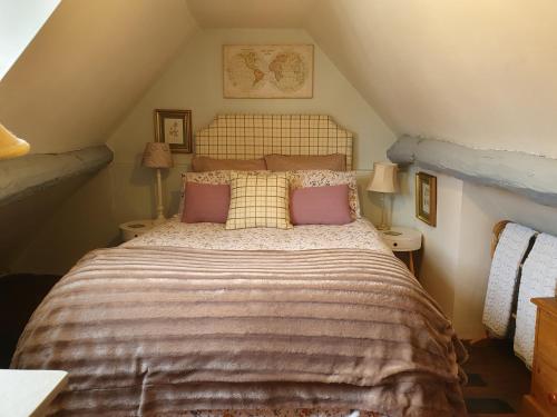 a bedroom with a large bed in a attic at The Poop Deck in Upton upon Severn