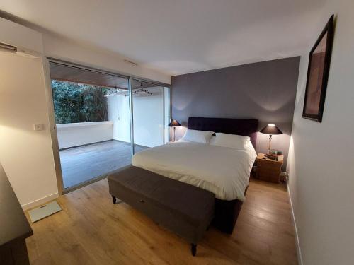 a bedroom with a bed and a large window at barbiccaja in Ajaccio