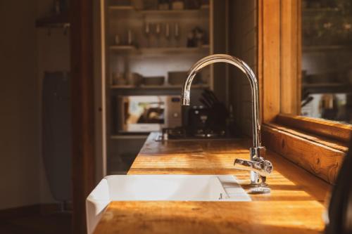 a kitchen counter with a sink and a window at Kaimata Cozy in Dunedin